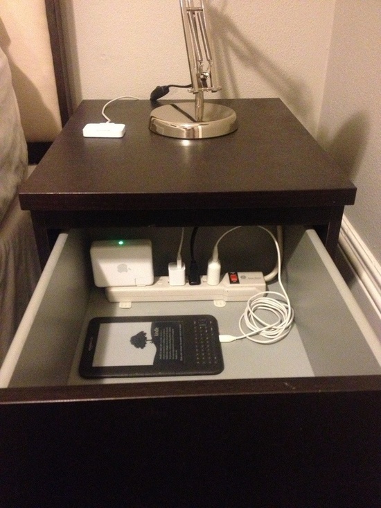 Cool if you can handle sacrificing a drawer- Put a power strip in the top drawer of your nightstand to charge/organize/hide your electronics.